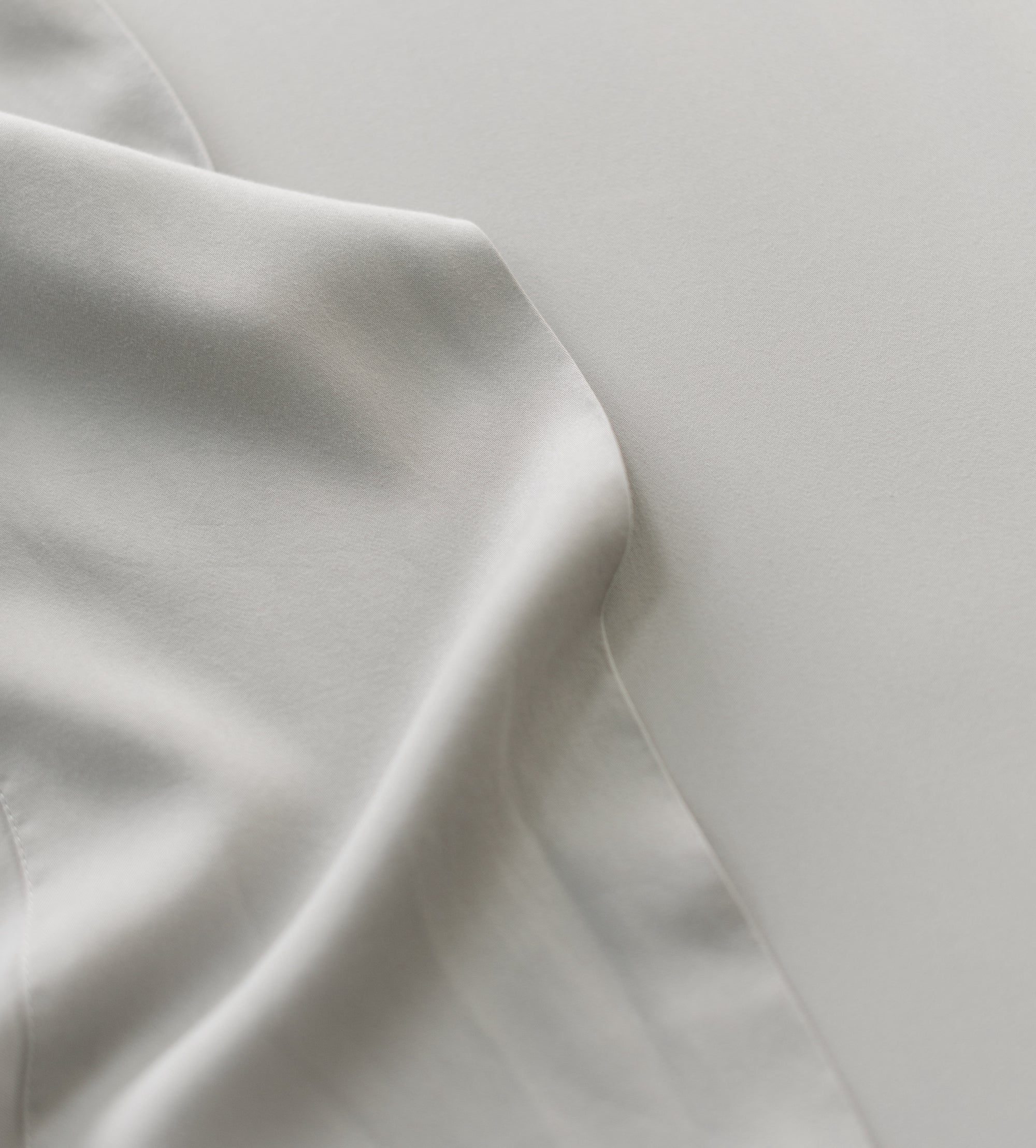 Close up of light grey bedding 