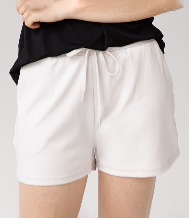 Person wearing Cozy Earth Brushed Bamboo Jogger Shorts in white and a black top