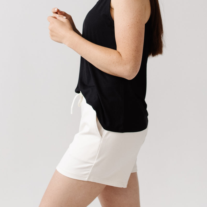 Person wearing Cozy Earth Brushed Bamboo Jogger Shorts in white and a black top
