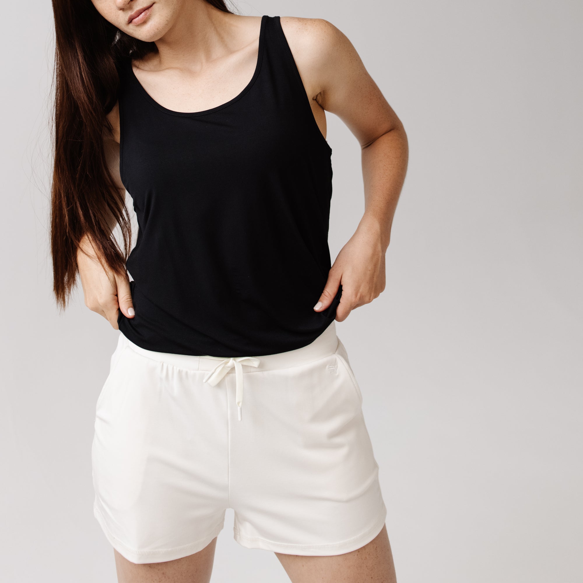 Person wearing Cozy Earth Brushed Bamboo Jogger Shorts in white and a black top 