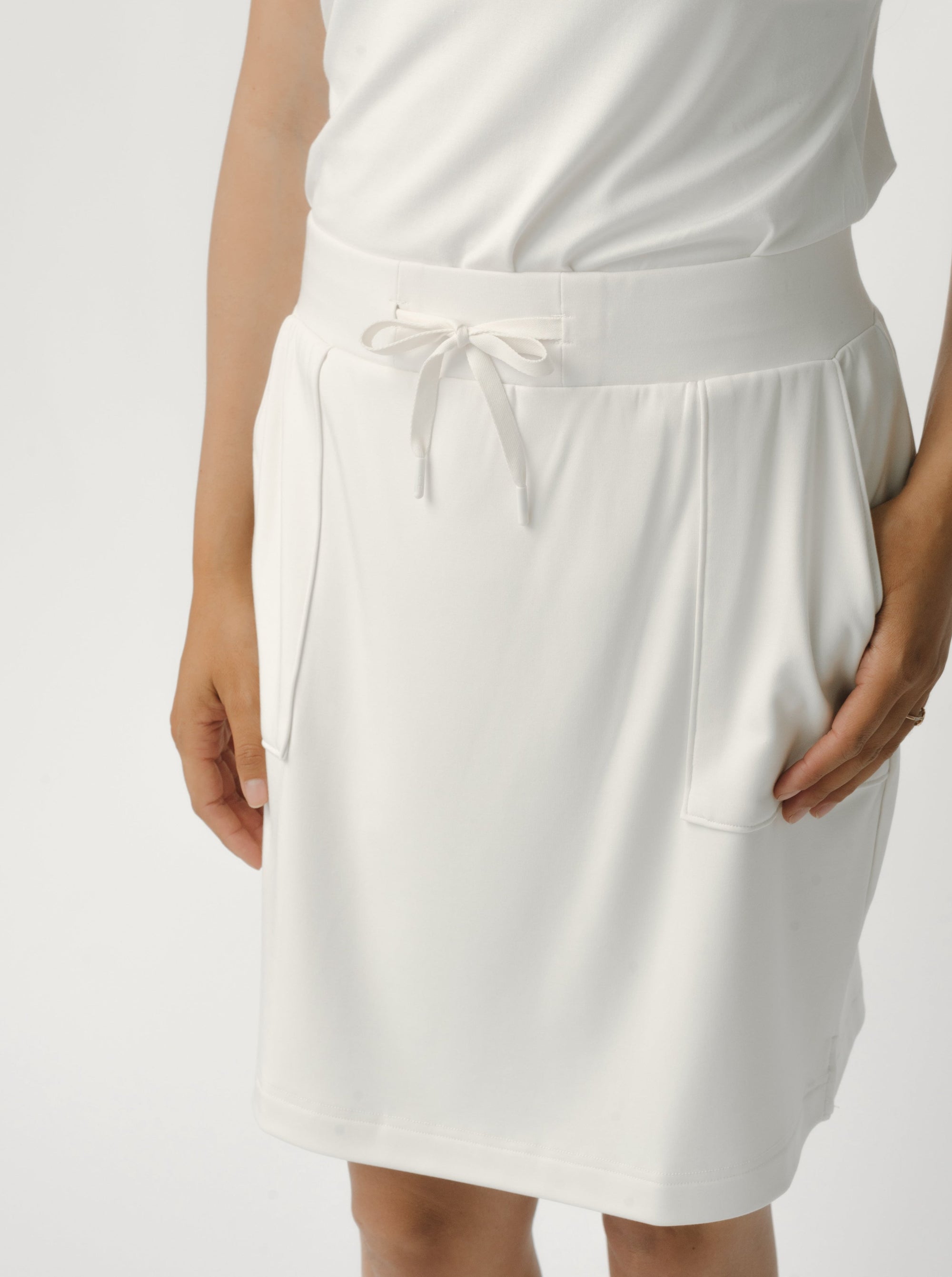 Person wearing a Cozy Earth Brushed Bamboo Patch Pocket Skirt in white on a white background 