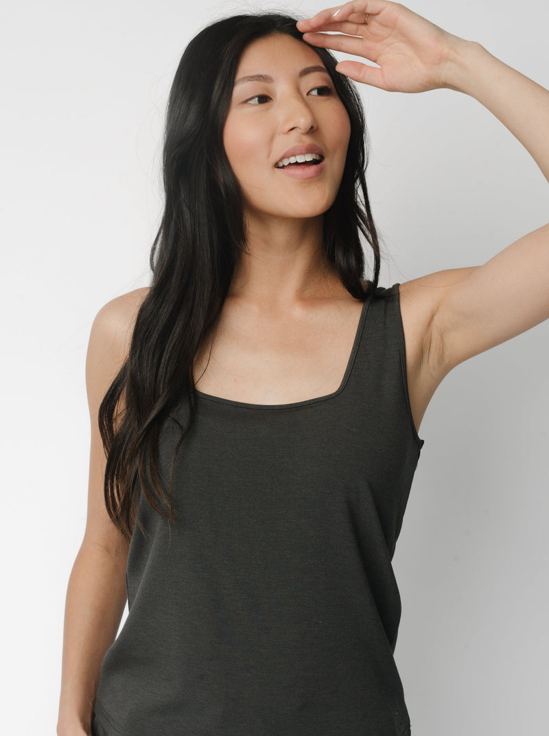 A woman wears Charcoal Women’s Ultra-Soft Bamboo Square Neck Tank in front of a white background