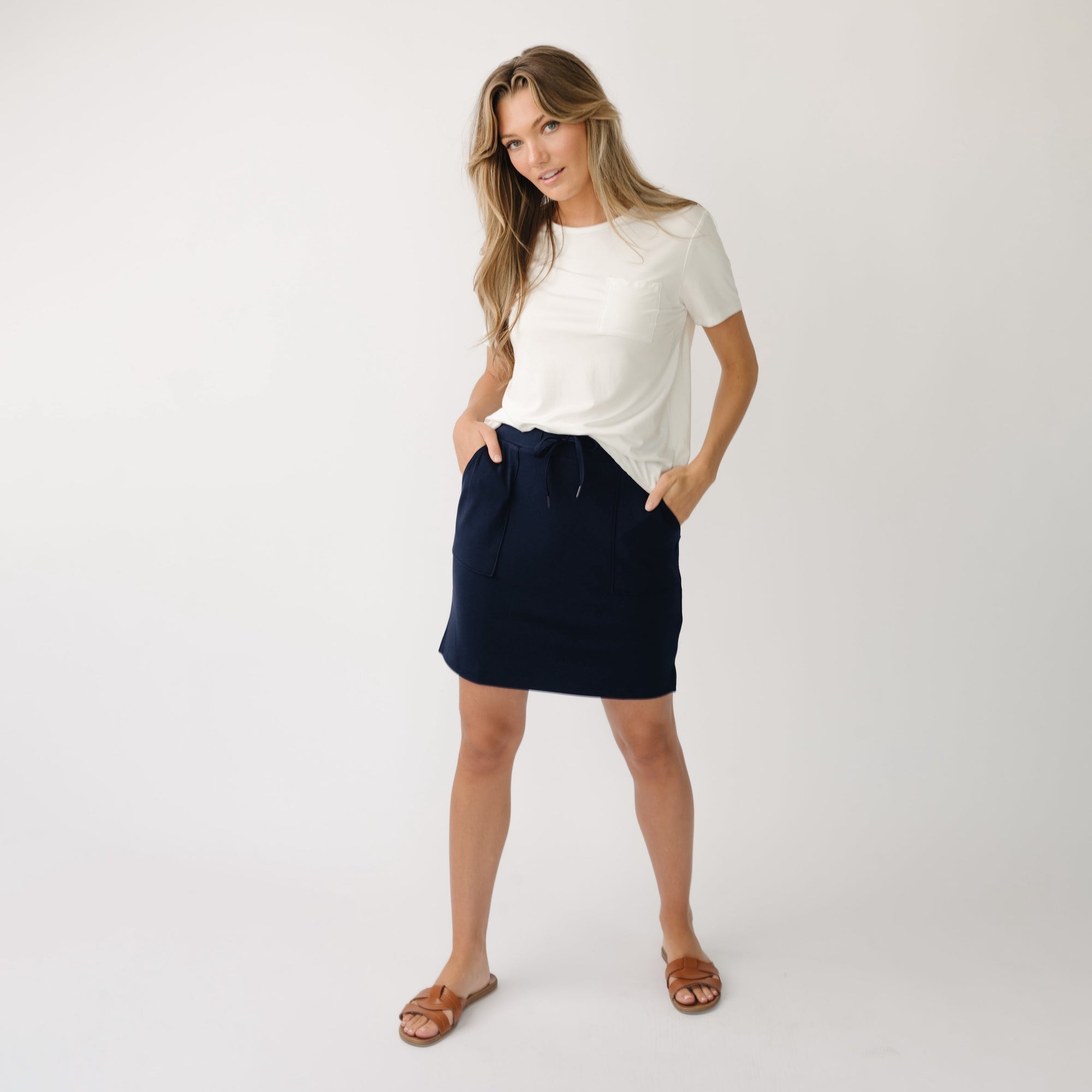 Person wearing a Cozy Earth Brushed Bamboo Patch Pocket Skirt in navy on a white background 
