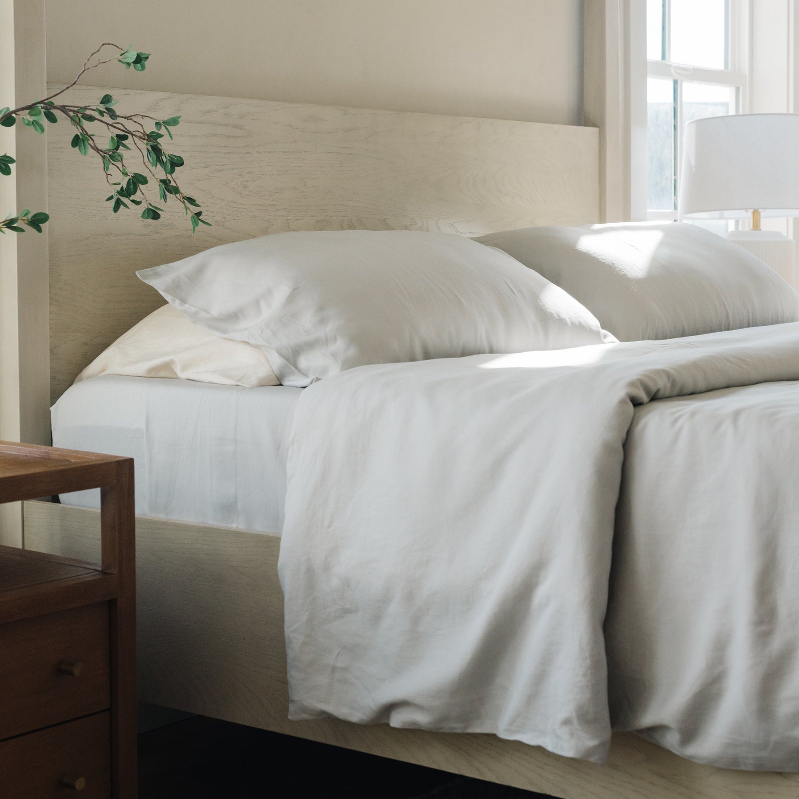 Light Grey Bamboo Linen Pillow Cases on a creme bed. 