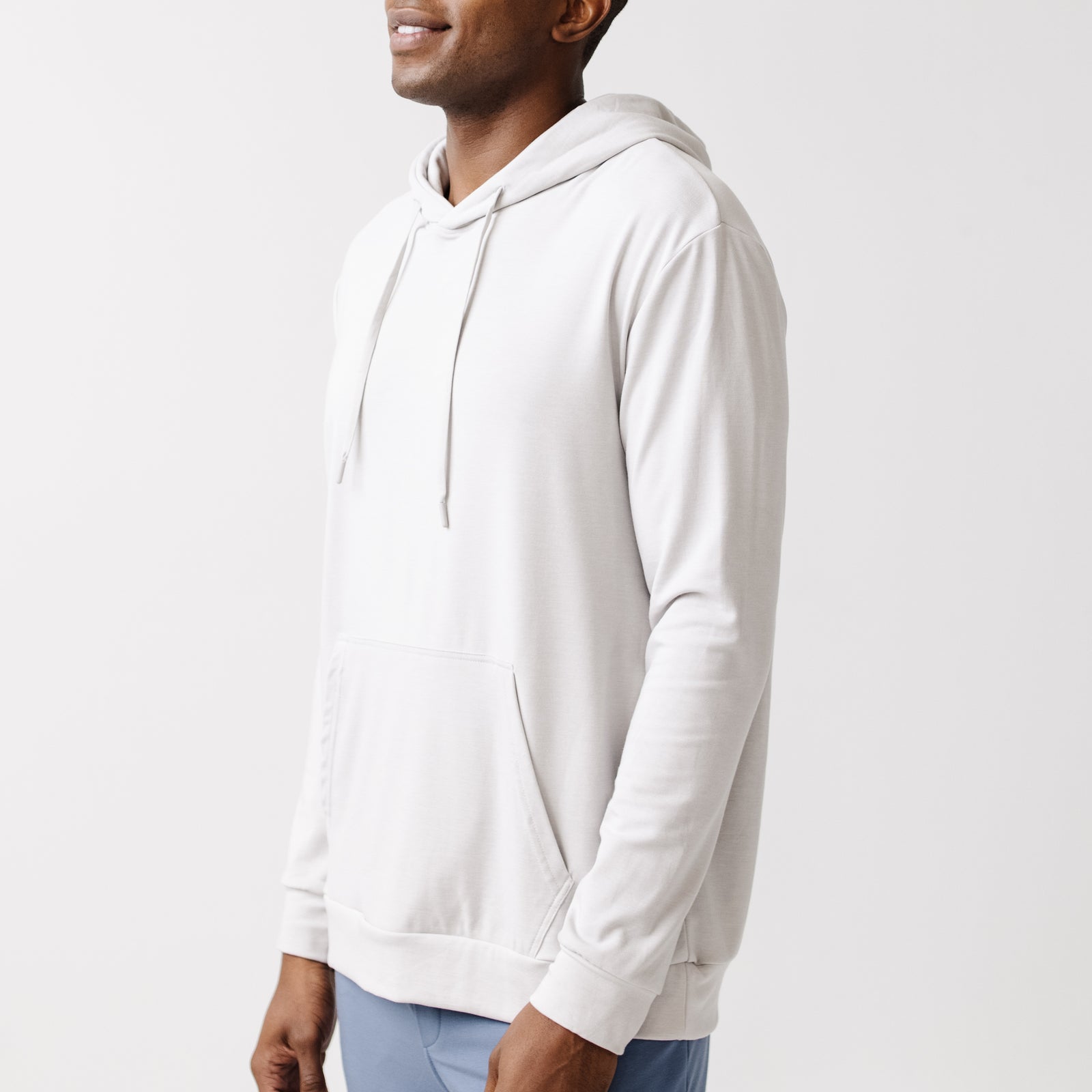 Light Grey Bamboo Hoodie worn by a man standing in front of white background.