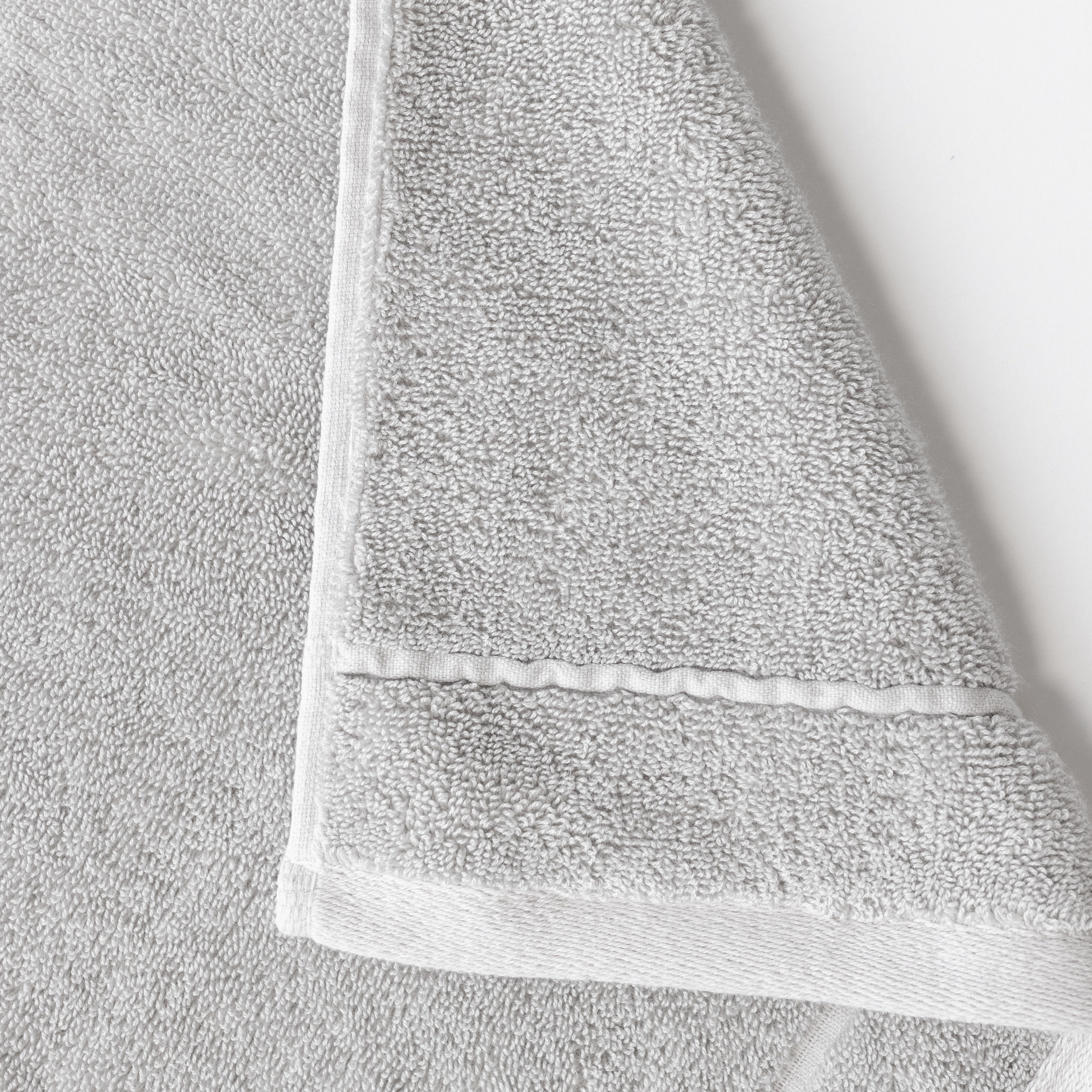 Light Grey Premium Plush Bath Towel. Photo of Premium Plush Bath Towels taken on a white background showing only the corner of the towel. |Color:Light Grey 