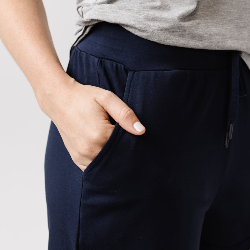Person wearing Cozy Earth Brushed Bamboo Jogger Shorts in navy and a navy top