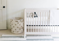 wooden crib bed made with white bamboo crib sheet 