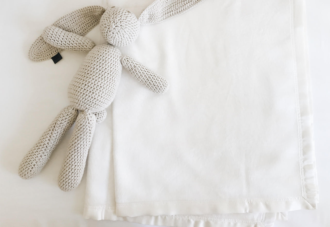 white bamboo crib sheet with stuffed animal