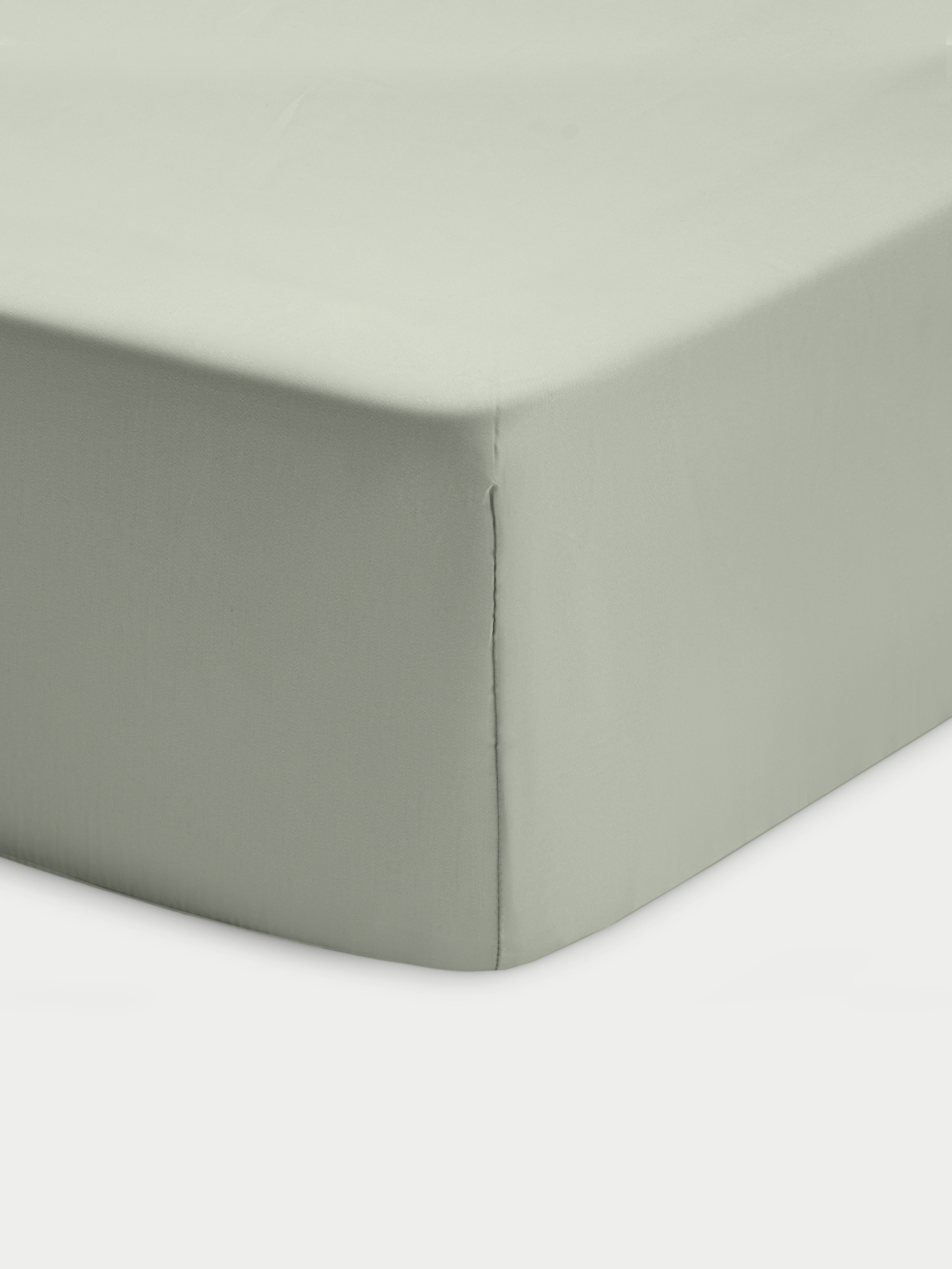 Corner of sage crib sheet with white background 