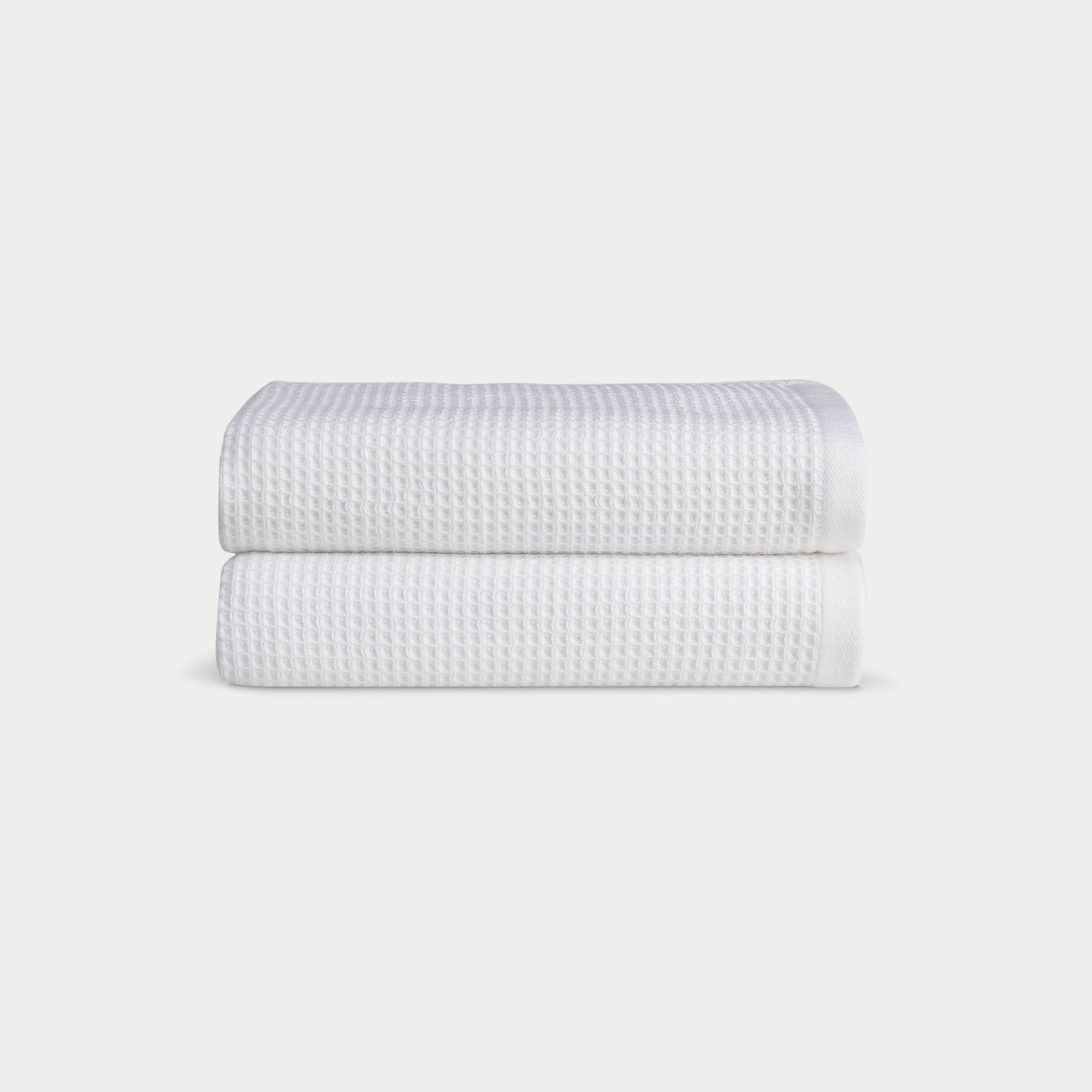 White Waffle Hand Towel set neatly folded. The photo was taken with a white background. |Color:White