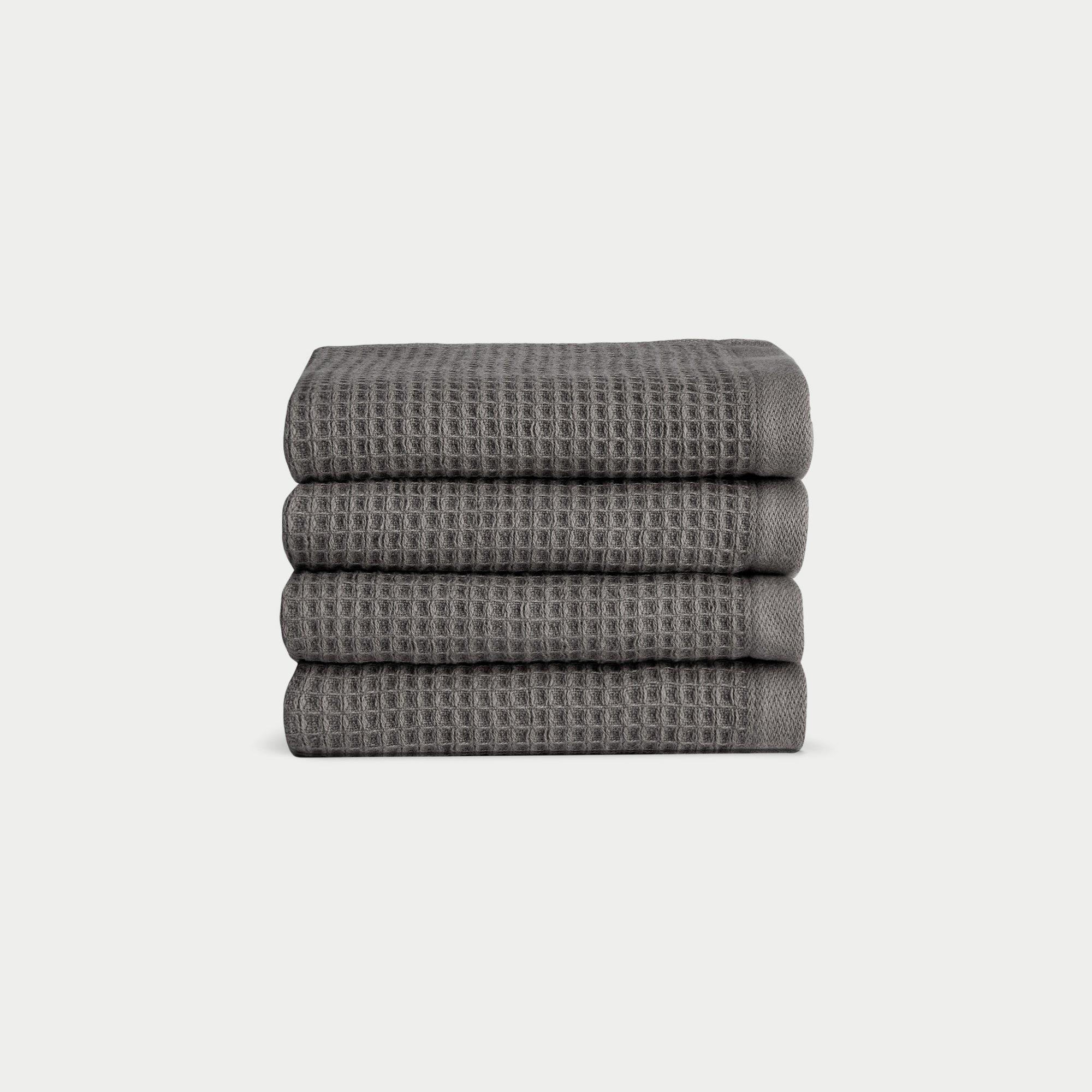 Charcoal Waffle Wash Cloths neatly folded. The photo was taken with a white background. |Color:Charcoal