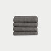 Charcoal Waffle Wash Cloths neatly folded. The photo was taken with a white background. |Color:Charcoal