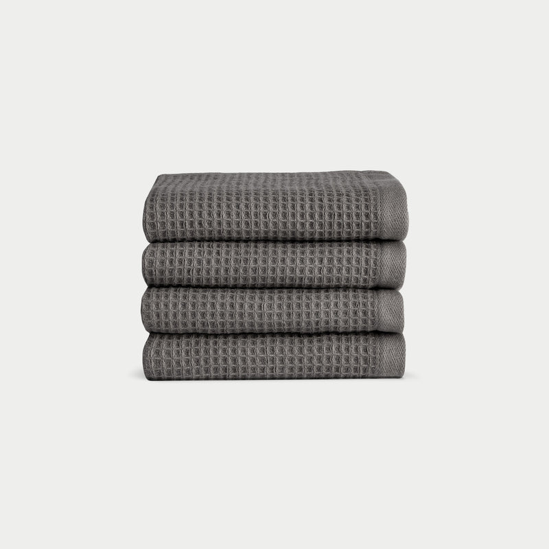 Charcoal Waffle Wash Cloths neatly folded. The photo was taken with a white background.
