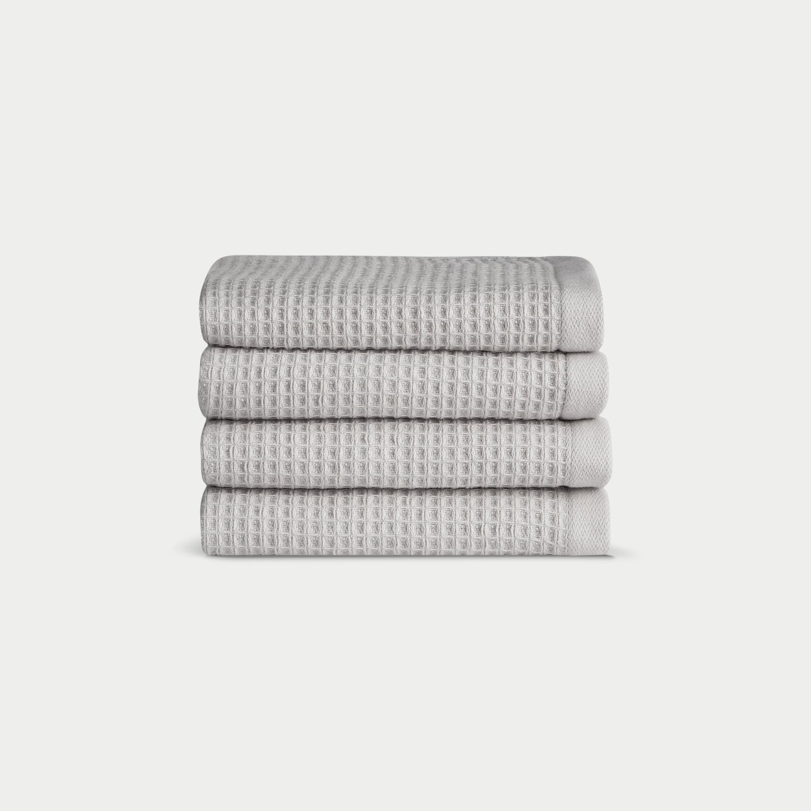 Light Grey Waffle Wash Cloths neatly folded. The photo was taken with a white background. 