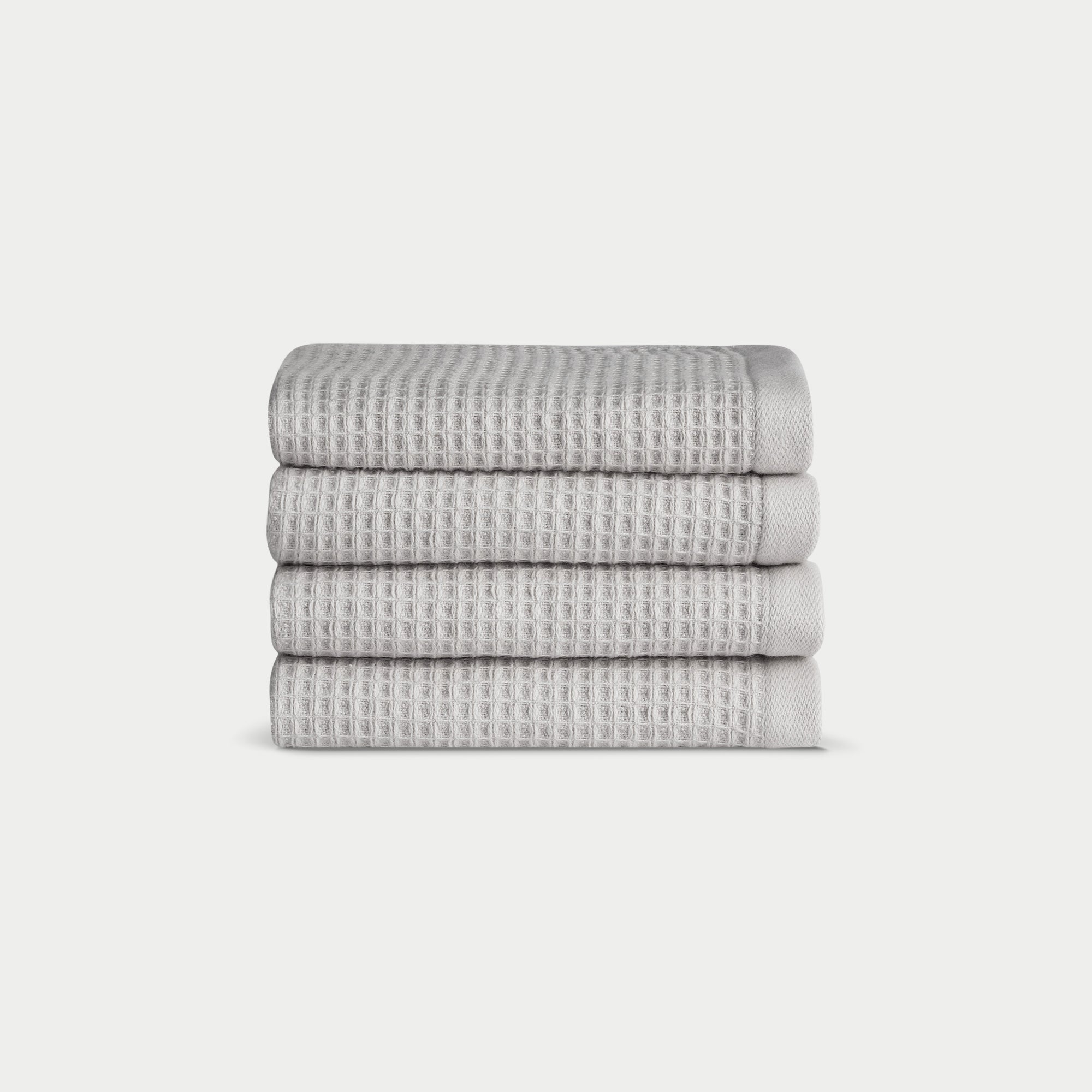 Light Grey Waffle Wash Cloths neatly folded. The photo was taken with a white background. |Color:Light Grey