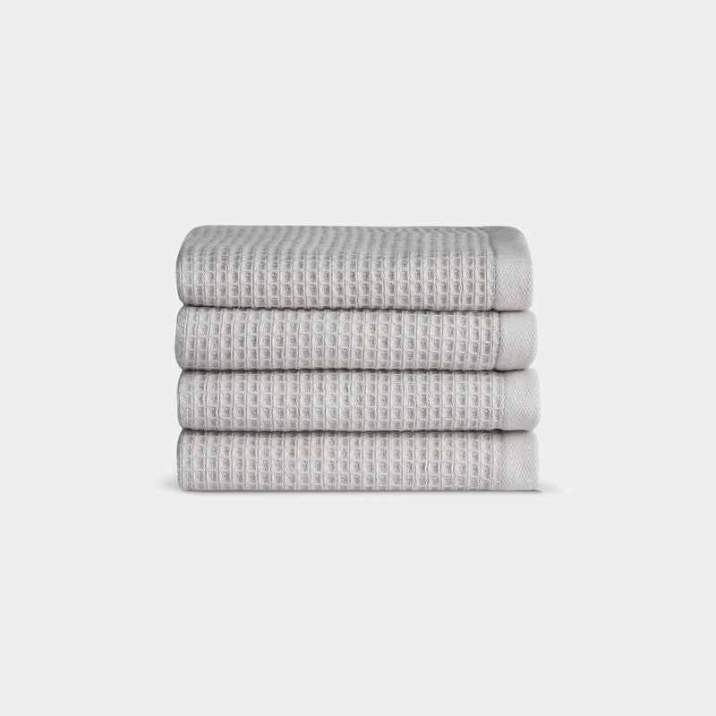 Light Grey Waffle Wash Cloths neatly folded. The photo was taken with a white background.