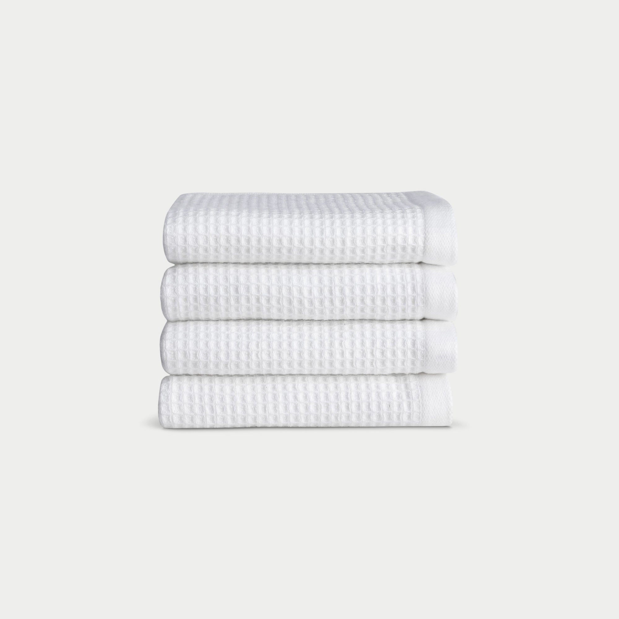 White Waffle Wash Cloths neatly folded. The photo was taken with a white background. |Color:White