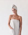 Light Grey Waffle Hair Towel. The hair towel is shown being worn by a woman. The photo was taken with a white background. |Color:Light Grey