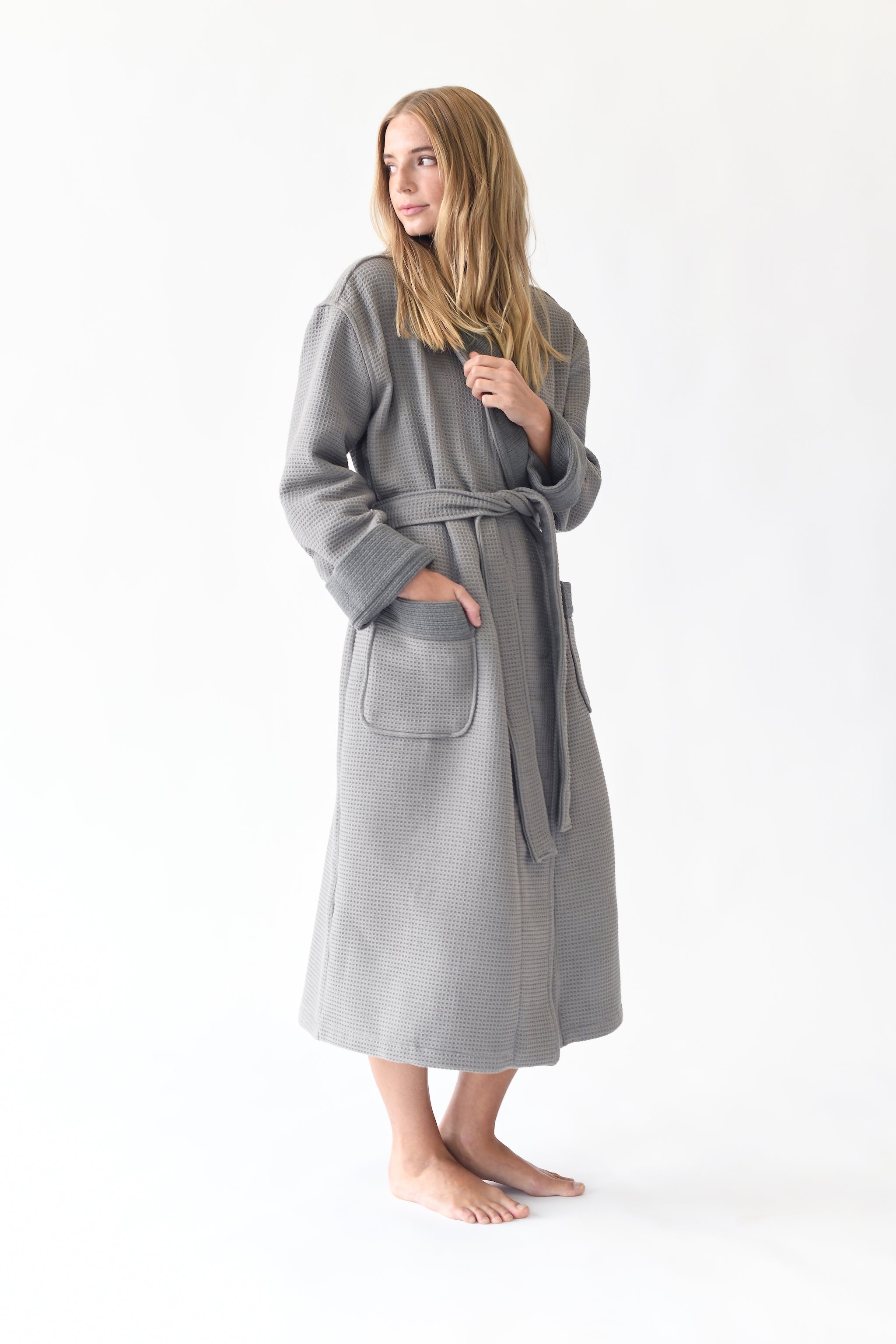Woman wearing Bamboo Waffle Bath robe standing in front of a with a white background. |Color:Charcoal