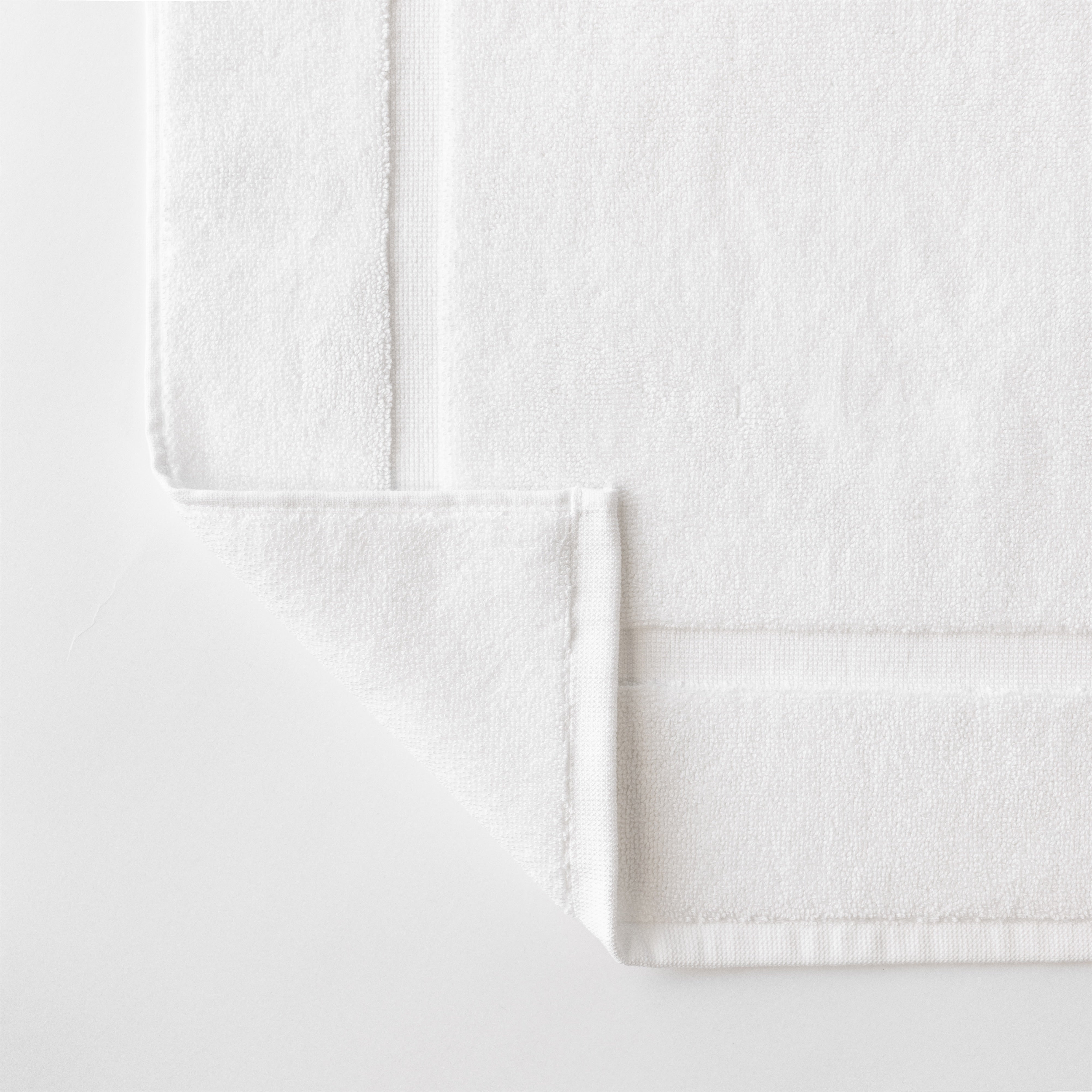 Close up shot of the Premium Plush Bath Mat. This shot shows only the mat so that the texture of the bath mat can be seen with more clarity|Color:White