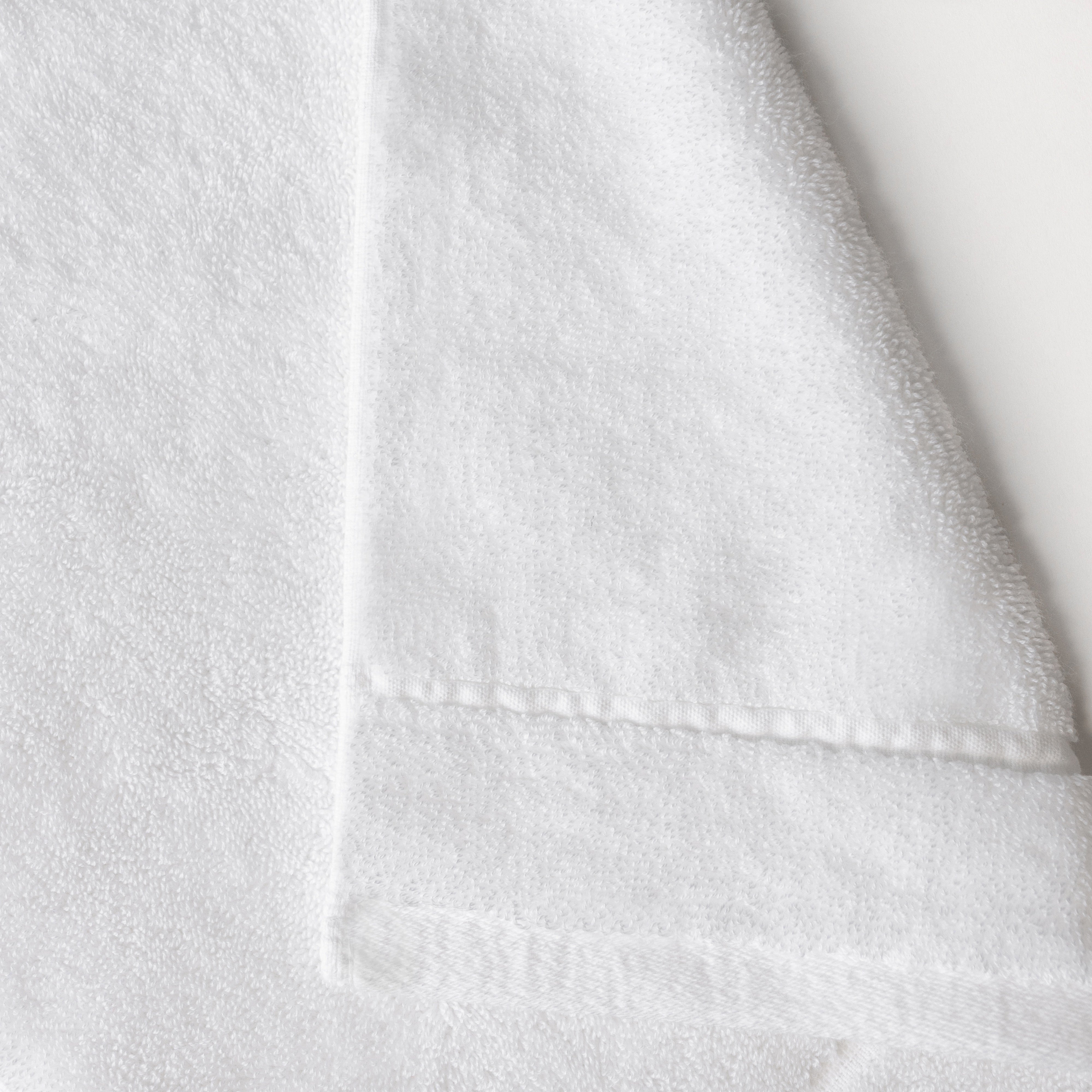White Premium Plush Bath Towel. Photo of Premium Plush Bath Towels taken on a white background showing only the corner of the towel. |Color: White