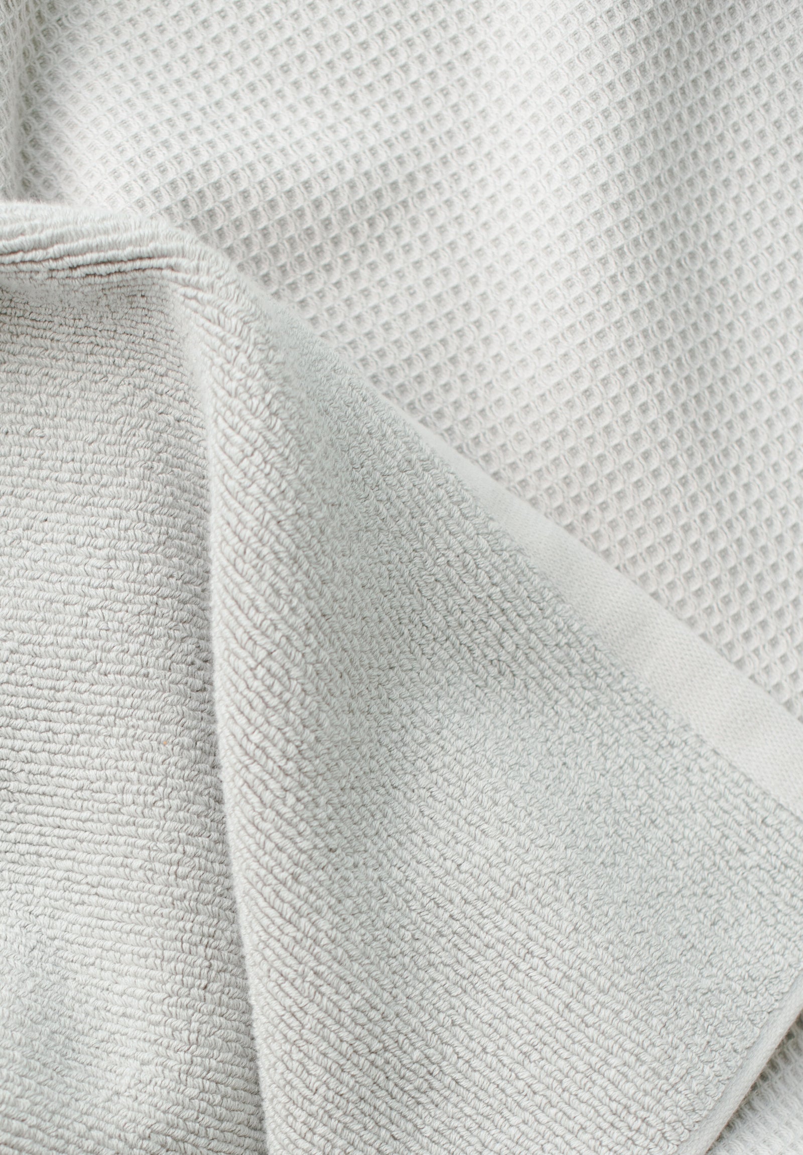 Waffle Bath Towel in the color Light Grey. Photo of Light Grey Waffle Bath Towel taken close up only showing the towel 