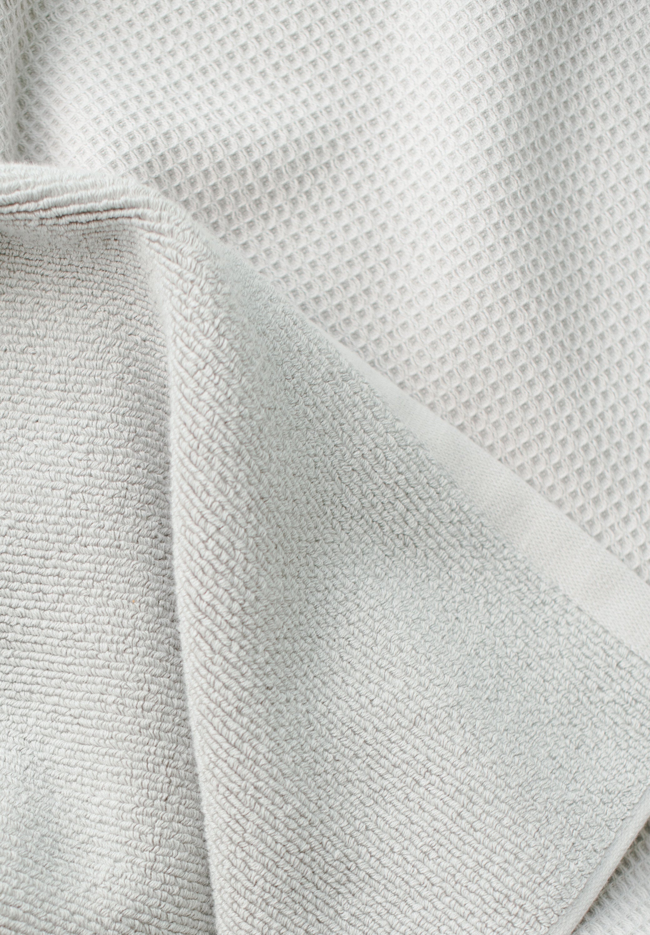 Waffle Bath Towel in the color Light Grey. Photo of Light Grey Waffle Bath Towel taken close up only showing the towel |Color: Light Grey