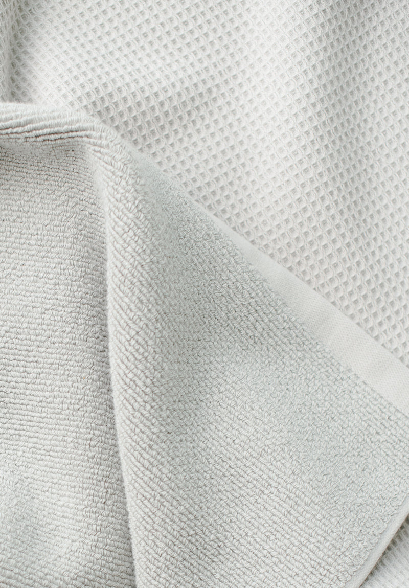 Waffle Bath Towel in the color Light Grey. Photo of Light Grey Waffle Bath Towel taken close up only showing the towel