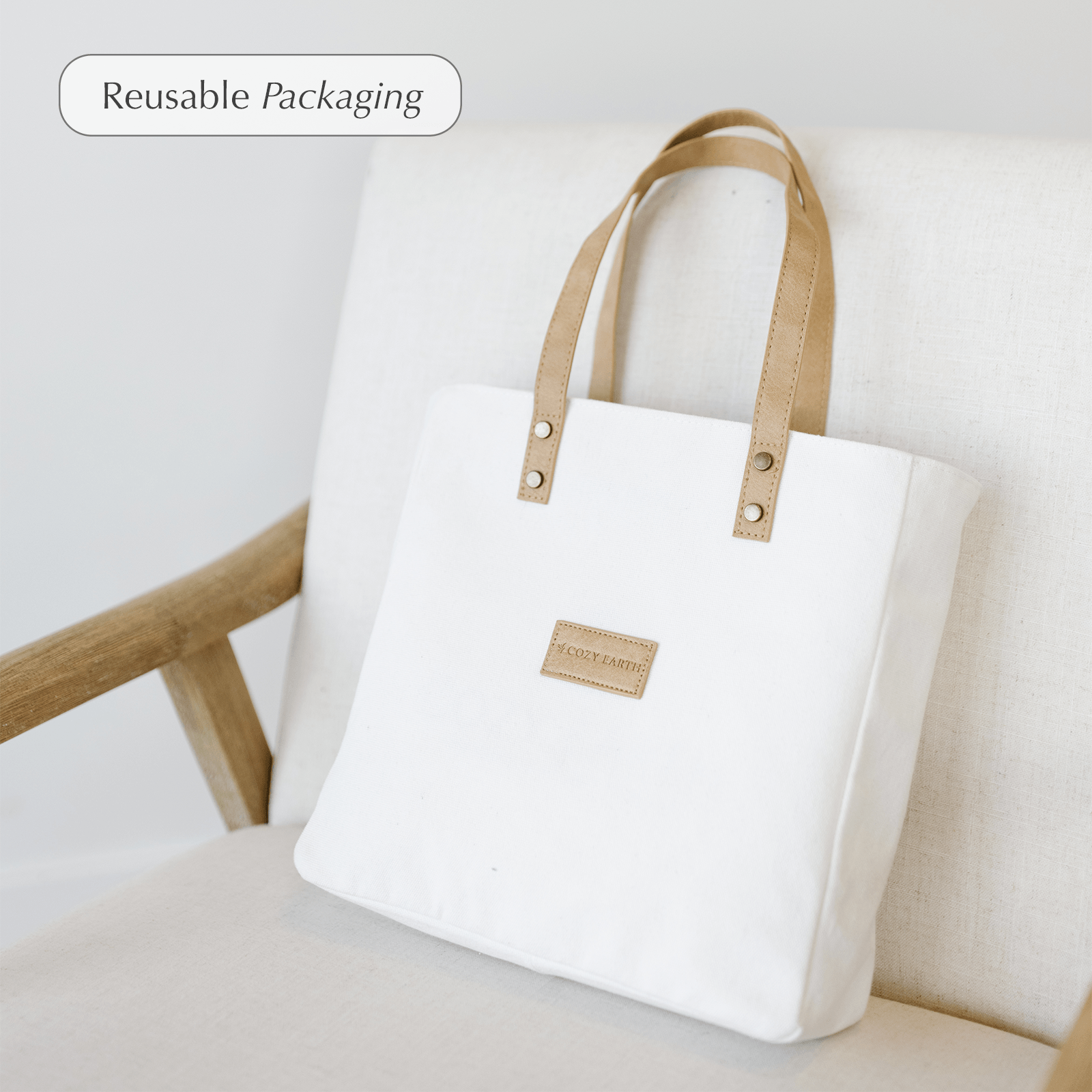 Duvet cover bag sitting on a chair. Comes with duvet covers in White, Oat, Driftwood, Charcoal, Light Grey, Olive, Navy, Sage, Harbor Mist, Clay, Walnut, Pacific Blue, Stone, Creme, Shore, and Dove Grey 