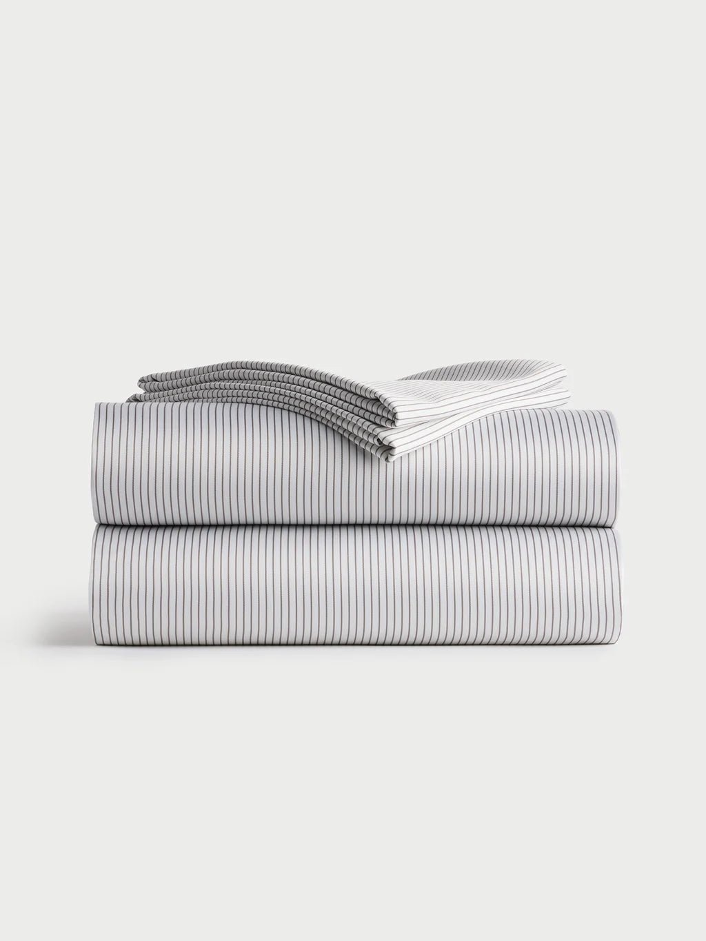 Folded black striped sheets on a plain background.