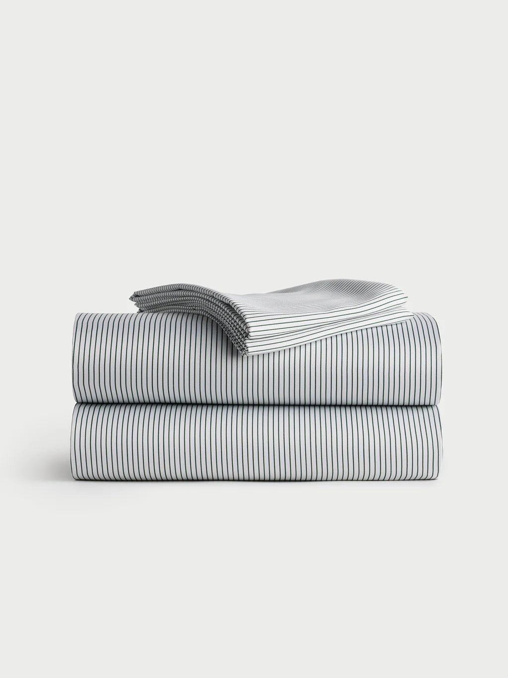 Folded striped sheets stacked neatly on a plain background.
