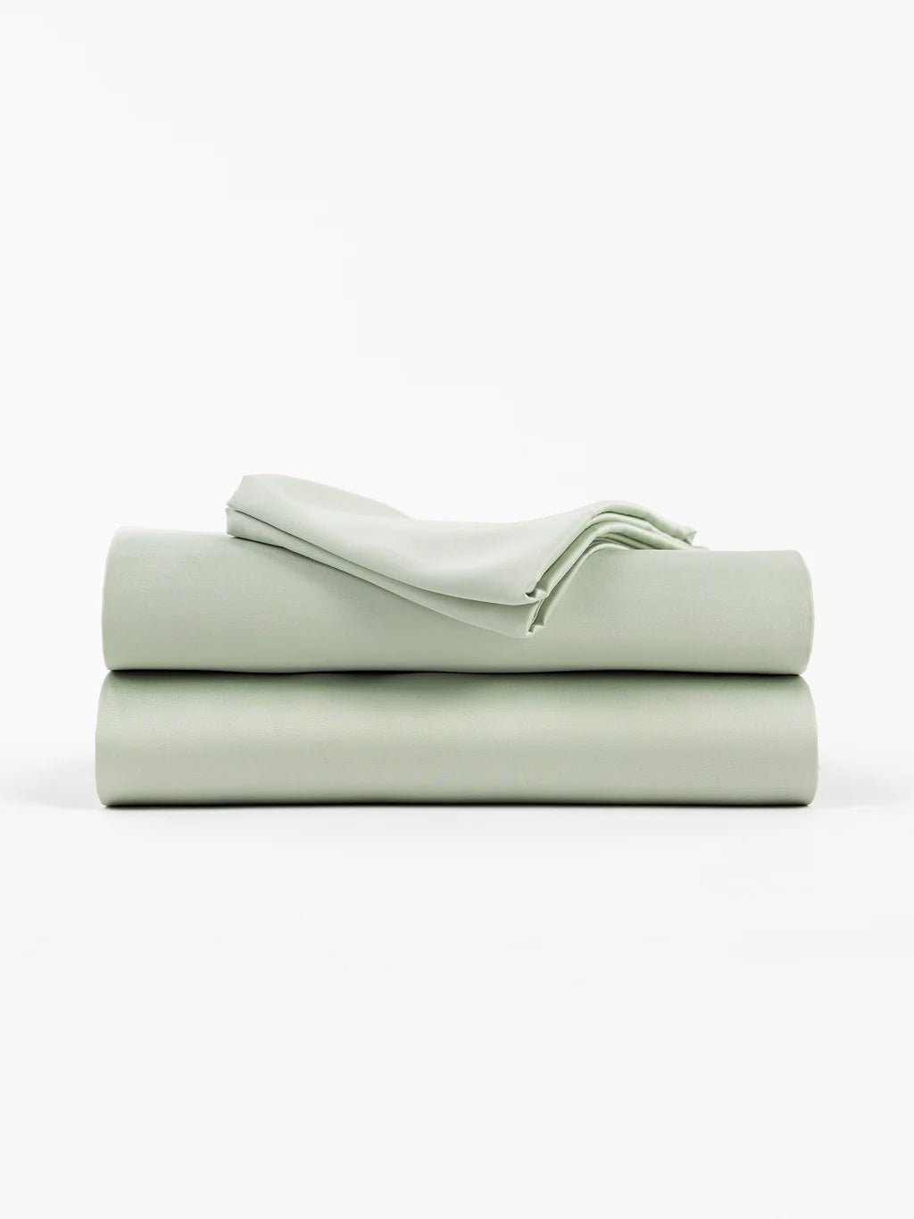 A folded stack of light green bed sheets on a white background.