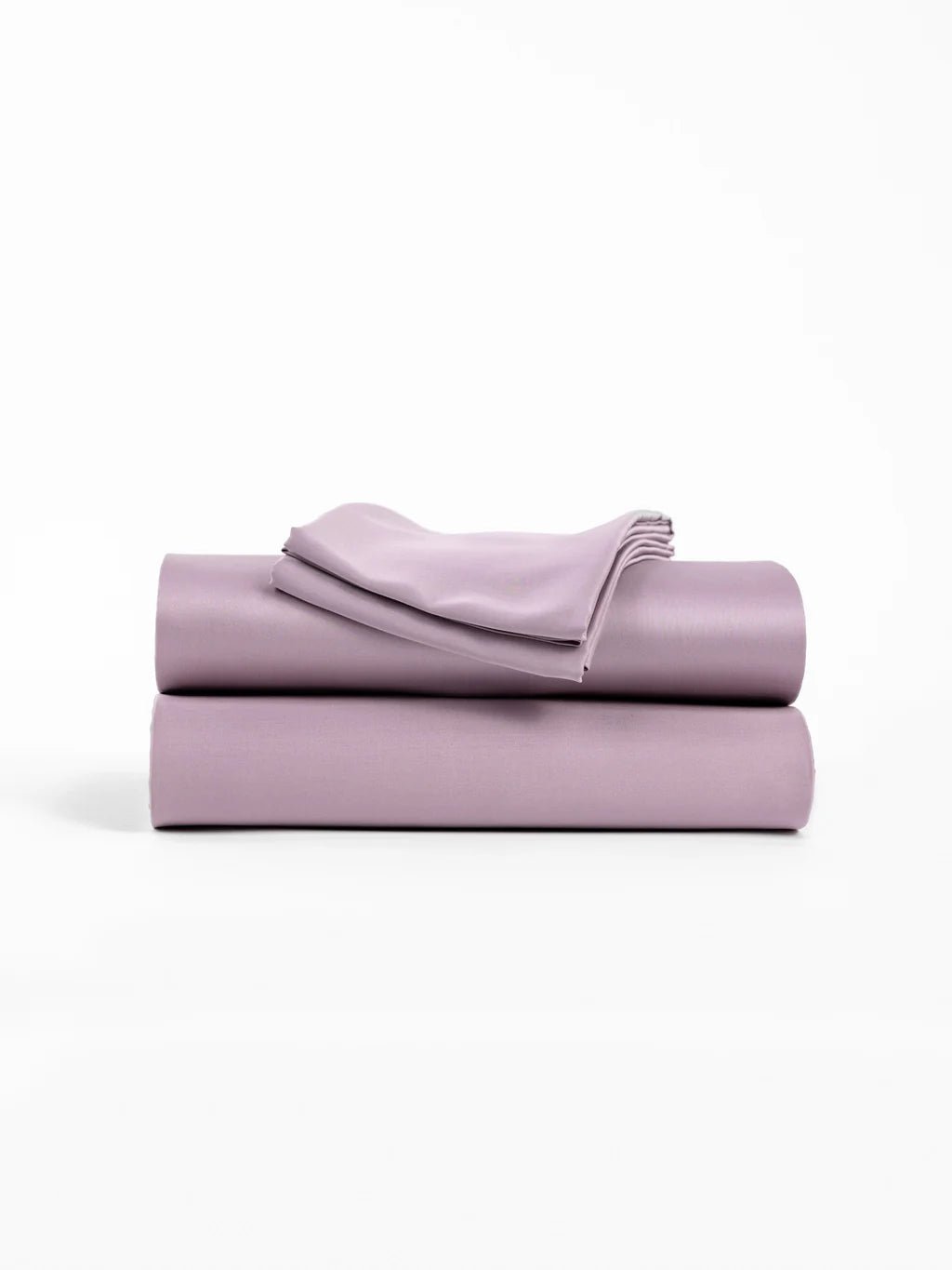 Folded lilac bedding set on a white background.