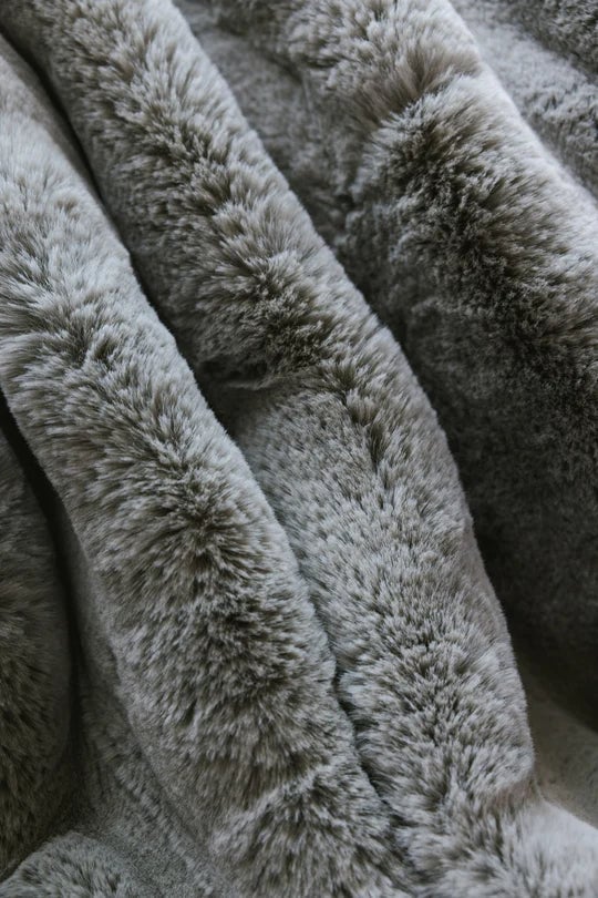 Close-up of soft, gray faux fur fabric with a fluffy texture.