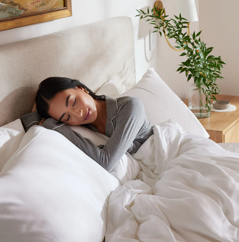 Woman resting in plush bed