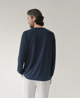 Man wearing a navy blue Modal sweatshirt from Cozy Earth